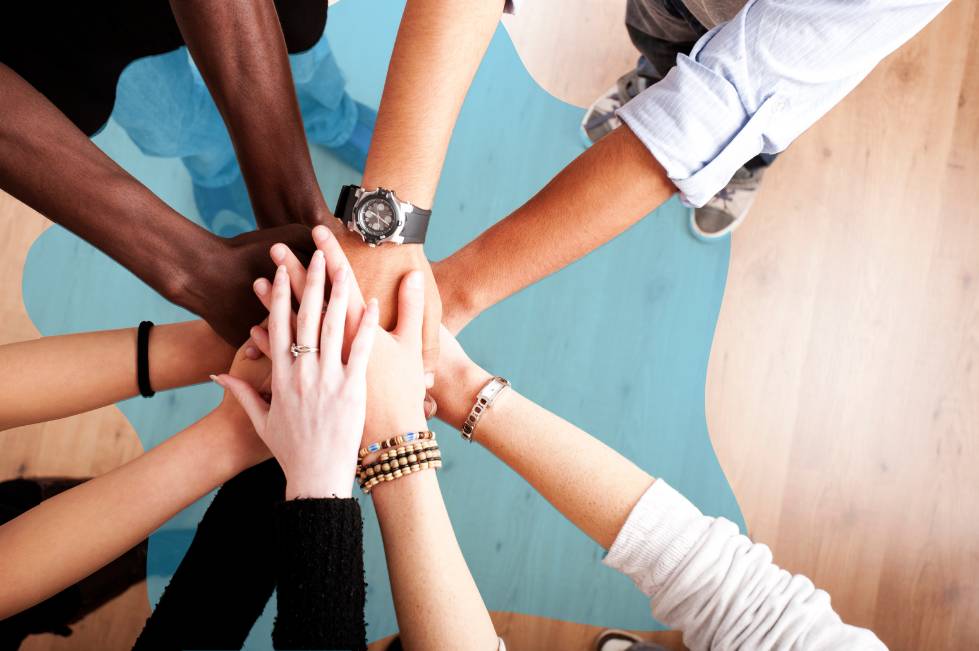 Adults hands together in a circle